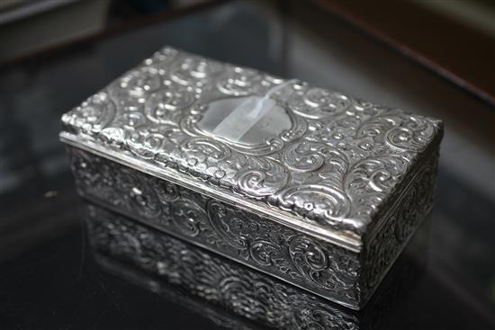 An Edwardian embossed silver rectangular cigarette box, 8.5in.